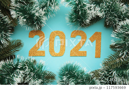 Happy New Year. Symbol from number 2021 and christmas decoration on blue wooden background. 117593669