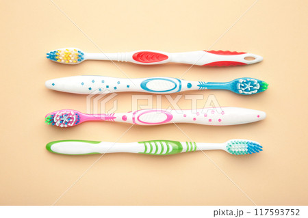 Toothbrushes on beige background with copy space. 117593752