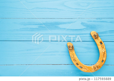 Gold horseshoe on blue background. St. Patricks day 117593889