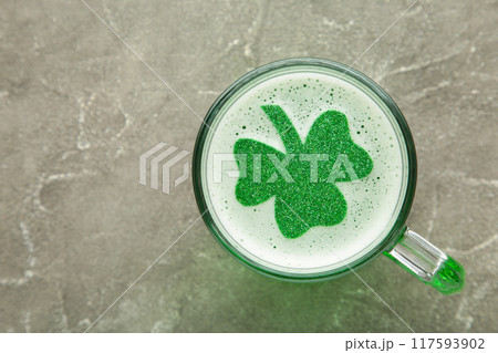 St. Patricks Day. Clover in Beer Mug on grey background with space for copy, text, your words. St. Patricks Day. Clover in Beer Mug on grey background with space for copy, text, your words. 117593902