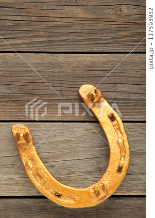 Gold horseshoe on grey background. St. Patricks day Gold horseshoe on grey background. St. Patricks day 117593932