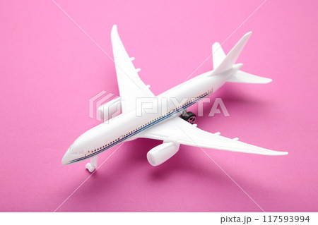 Model airplane on pink pastel color background. Model airplane on pink pastel color background. 117593994