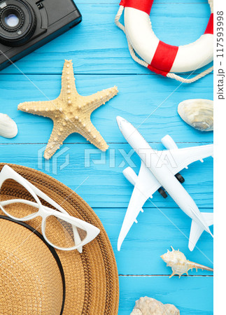 Airplane with traveler accessories on blue background. Travel concept. Vertical foto 117593998