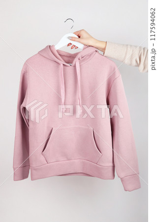 Woman wearing empty pink hoodie in hand, mockup for your own design 117594062
