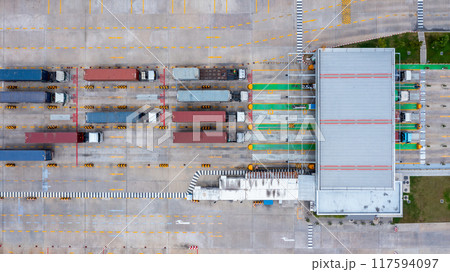 Aerial view semi truck with container at distribution center industrial logistic zone, Logistics park with warehouse loading hub and semi truck cargo trailer. 117594097