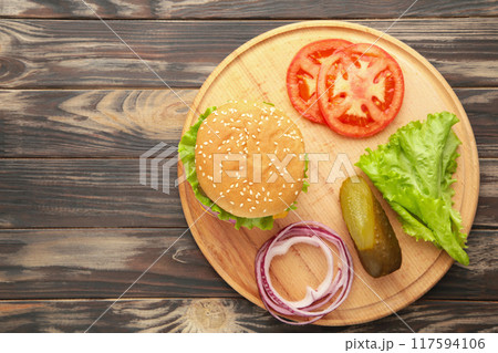 Homemade burger ingredients arranged on wooden background Homemade burger ingredients arranged on wooden background 117594106