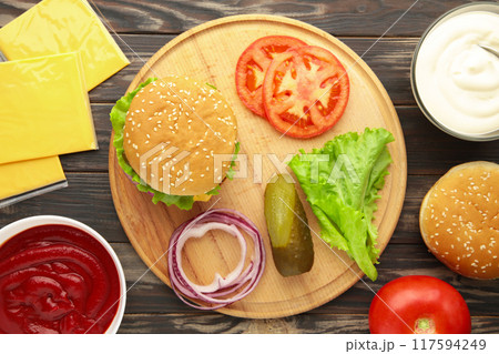 Homemade burger ingredients arranged on wooden background Homemade burger ingredients arranged on wooden background 117594249