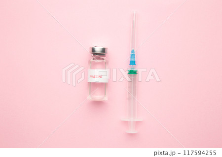 Coronavirus COVID-19 vaccine vials and syringe on pink background with copy space. 117594255