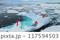 Antarctica 28.11.2019- People on large floating ice iceberg in Antarctica. Scientists from polar station expedition outdoor. Icy landscape, melting glacier, wild nature of South Pole. Aerial shot 117594503