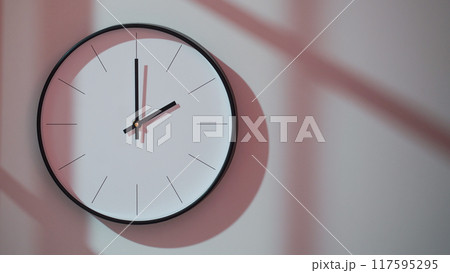 Elegant Black Clock Showing 14.00/22.00 with Shadows on Minimalist Wall - Ideal for Time Management and Interior Design Promotions Elegant Black Clock Showing 14.00/22.00 with Shadows on Minimalist Wall - Ideal for Time Management and Interior Design Promotions 117595295