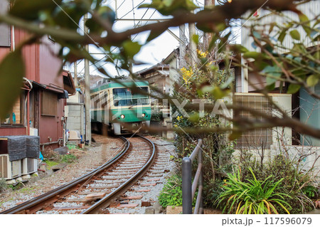 狭い路地を縫って走る江ノ電 117596079