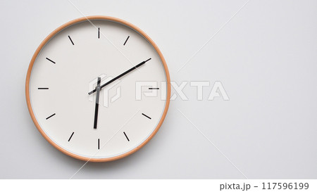 Minimalist wooden Wall Clock on White Wooden Surface with Space for Text. Time Set at 18.10/06.10 Minimalist wooden Wall Clock on White Wooden Surface with Space for Text. Time Set at 18.10/06.10 117596199