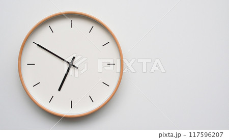 Minimalist wooden Wall Clock on White Wooden Surface with Space for Text. Time Set at 18.50/06.50 Minimalist wooden Wall Clock on White Wooden Surface with Space for Text. Time Set at 18.50/06.50 117596207