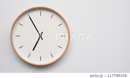 Minimalist wooden Wall Clock on White Wooden Surface with Space for Text. Time Set at 18.55/06.55 Minimalist wooden Wall Clock on White Wooden Surface with Space for Text. Time Set at 18.55/06.55 117596208