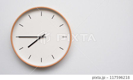 Minimalist wooden Wall Clock on White Wooden Surface with Space for Text. Time Set at 19.45/07.45 Minimalist wooden Wall Clock on White Wooden Surface with Space for Text. Time Set at 19.45/07.45 117596218