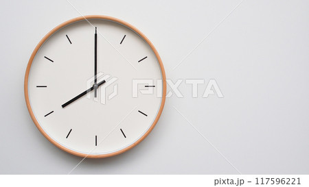 Minimalist wooden Wall Clock on White Wooden Surface with Space for Text.  Time Set at 20.00/08.00 117596221