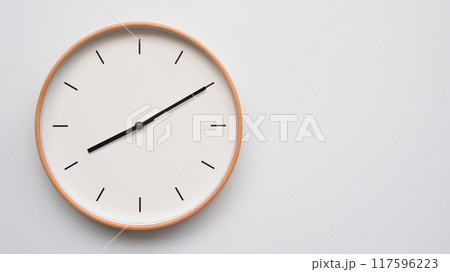 Minimalist wooden Wall Clock on White Wooden Surface with Space for Text. Time Set at 08.10/20.10 Minimalist wooden Wall Clock on White Wooden Surface with Space for Text. Time Set at 08.10/20.10 117596223