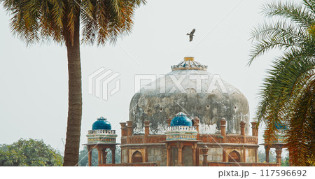 New Delhi, Delhi, India. Black Kite bird flying above Babur's Tomb near The Humayun's tomb. Famous place is Tomb of Mughal emperor, Mirza Nasir al-Din Muhammad commonly known as Humayun situated in New Delhi, Delhi, India. Black Kite bird flying above Babur's Tomb near The Humayun's tomb. Famous place is Tomb of Mughal emperor, Mirza Nasir al-Din Muhammad commonly known as Humayun situated in 117596692