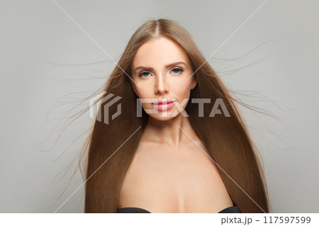Glorious female model brunette with long hair and natural make-up posing isolated 117597599