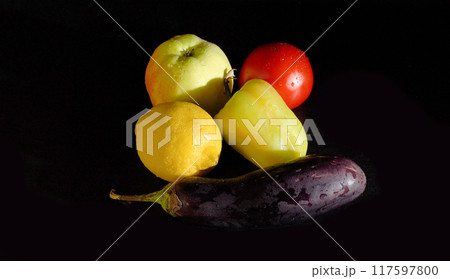 Ripe Yellow Lemon, Apple, Tomato, Sweet Pepper, and Eggplant on a Black Background 117597800