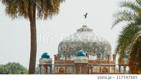 New Delhi, Delhi, India. Black Kite bird flying above Babur's Tomb near The Humayun's tomb. Famous place is Tomb of Mughal emperor, Mirza Nasir al-Din Muhammad commonly known as Humayun situated in 117597885