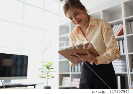 woman plans a finance and budget audit by reviewing organizing Home financial documents woman plans a finance and budget audit by reviewing organizing Home financial documents 117597943