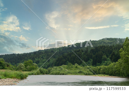 Beautiful view of morning sky reflections on lake's water. Mountains and hills panoramic landscape. Beautiful view of morning sky reflections on lake's water. Mountains and hills panoramic landscape. 117599533
