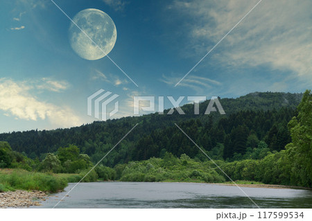 Full moon in the twilight or night cloudy blue sky. Mountains and river panoramic landscape. 117599534