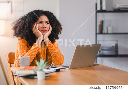 Stressed African American Woman at Desk with Laptop. Stressed African American Woman at Desk with Laptop. 117599664