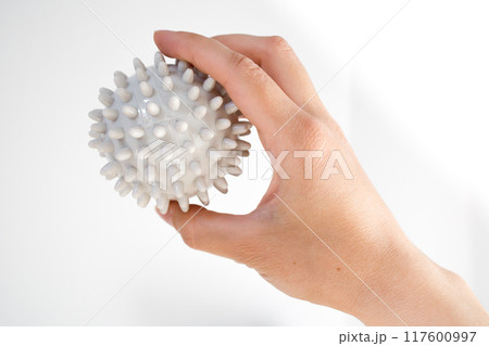 Lymphatic drainage massage spike ball in the hand Lymphatic drainage massage spike ball in the hand 117600997
