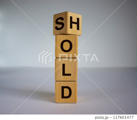 Wooden cubes and changes the word 'sold' to 'hold'. Beautiful white background. Business concept, copy space. 117601477