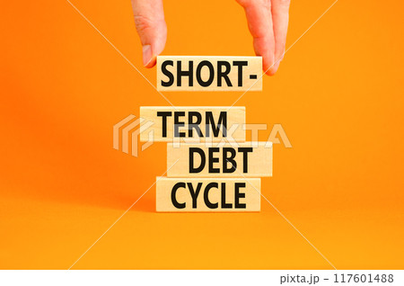Short-term debt cycle symbol. Concept words Short-term debt cycle on beautiful wooden block. Beautiful orange table background. Businessman hand. Business Short-term debt cycle concept. Copy space. 117601488
