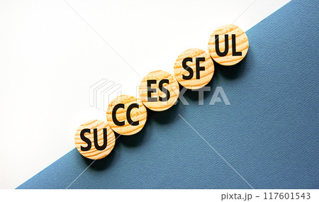 Successful symbol. Concept word Successful on beautiful wooden circles. Beautiful white and blue background. Business successful concept. Copy space. 117601543