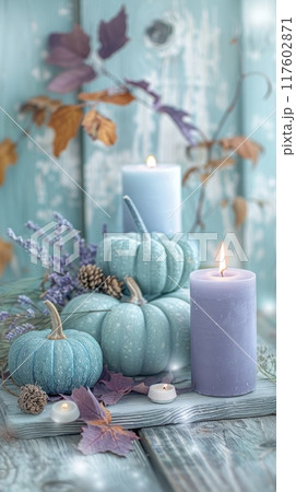 Thanksgiving decoration, pastel pumpkins, mint and lavender candles on wooden table. Vertical banner 117602871