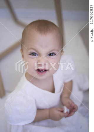 the baby is fussy, wrinkled nose and screams, grimaces the baby is fussy, wrinkled nose and screams, grimaces 117602937