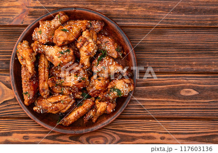 Caramelized in sause chicken wings . Bar-b-q food background photo Caramelized in sause chicken wings . Bar-b-q food background photo 117603136