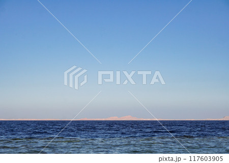 Red sea in Egypt and Tiran island (Saudi Arabia) arid mountains in the distance 117603905