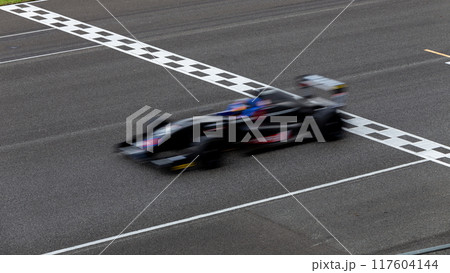 Motion blur race car racing on speed track, Car race on the international circuit race track crossing start and finish line, Race car crossing start and finish line, Target business achieve victory 117604144