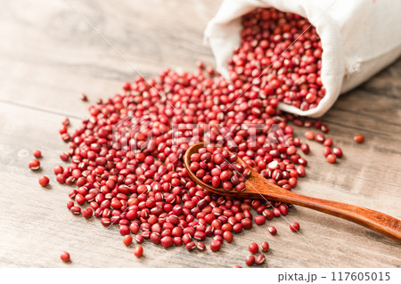 Red beans in cloth bag on wooden board 117605015