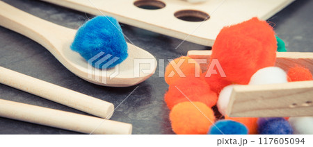 Colorful pompoms as accessories using for playing and development of kids motor skills Colorful pompoms as accessories using for playing and development of kids motor skills 117605094
