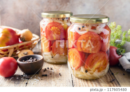Healthy homemade fermented food. Salted pickled tomatoes and onions preserved canned in glass jar. Home economics, autumn harvest preservation. Healthy homemade fermented food. Salted pickled tomatoes and onions preserved canned in glass jar. Home economics, autumn harvest preservation. 117605480