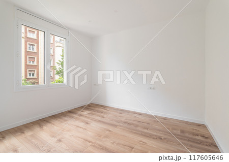 Imagine a bright, modernstyle empty room with wooden flooring and large windows 117605646