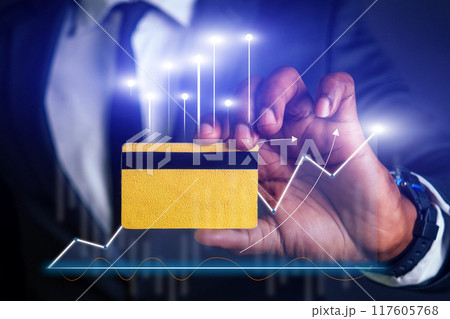 A man holding a credit card with a black stripe and a yellow stripe 117605768