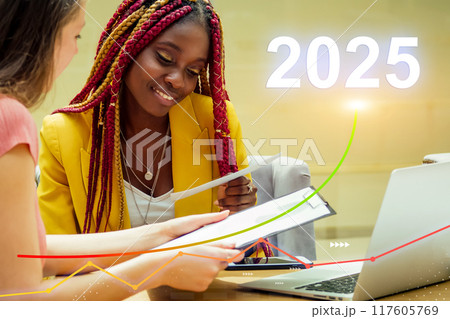 A woman in a yellow jacket is looking at a piece of paper, 2025 concept 117605769