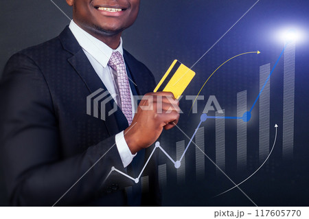A man is holding a yellow credit card and smiling A man is holding a yellow credit card and smiling 117605770