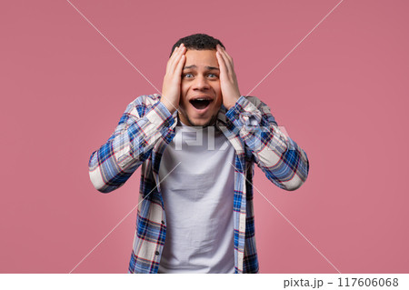 Screaming biracial man. Amazed guy glad, happy, surprised. excited dude on pink. 117606068