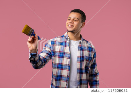 Creative Man Artist Imitates Painting With Brush On Pink Background. Fantasy Creative Man Artist Imitates Painting With Brush On Pink Background. Fantasy 117606081