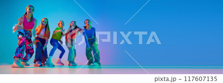 Dancers posing, showing their individuality throw moves in neon light against gradient background with negative space to insert text. 117607135