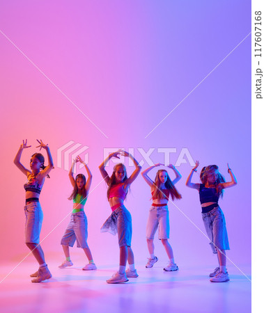 Poster. Group of artistic young girls dressed casual, sport attire moves in synch in neon light against gradient pink background. Poster. Group of artistic young girls dressed casual, sport attire moves in synch in neon light against gradient pink background. 117607168
