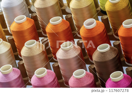 Close up the multi-color group of industry bobbin thread. 117607278